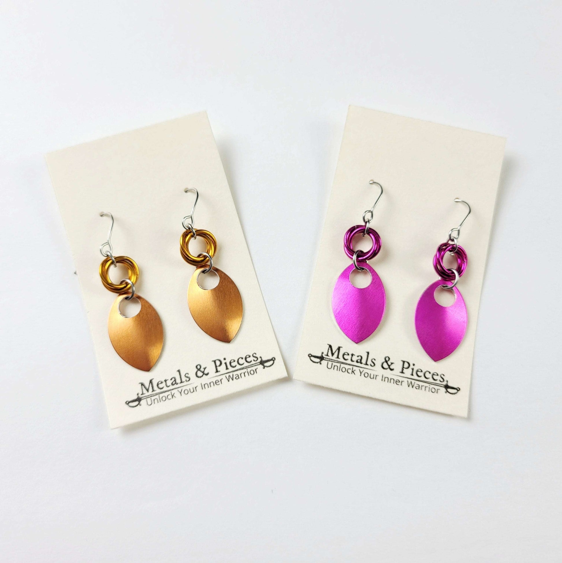 Lightweight scale earrings in orange and pink. 